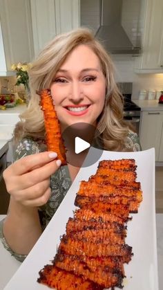 a woman holding up a large piece of food