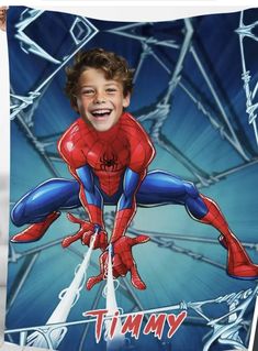 a young boy holding up a spider - man photo on a blue and white background