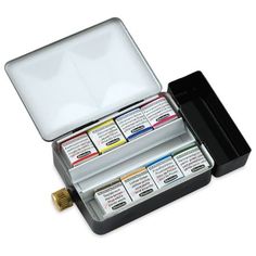 an open box with four different colored inks in it on a white background,