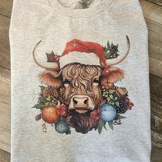 a cow wearing a santa hat with christmas decorations on it