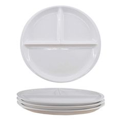 four white plates stacked on top of each other with one empty plate in the middle