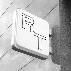 a sign on the side of a building that says r is for rat and it appears to be in black and white