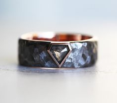 a black diamond ring sitting on top of a table