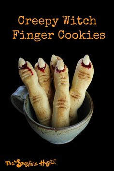 four creepy looking cookies in a bowl with the words creepy witch finger cookies written on them