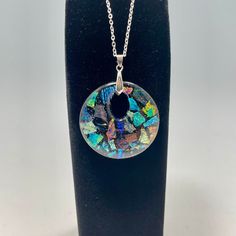 A beautiful dichroic Black round Pendant Beautiful Jewelry - Dichroic glass is fascinating s it sparkles and each individual dichroic glass has a transmitted color and a completely different reflected color, as certain wavelengths of light either pass through or are reflected. The necklace will be delivered in a box. Dimensions of pendant: 2" The stainless steel chain is 18” Artistic Process: A mosaic of different dichroic glass on top of Black casted into a round shape with a hole in it. Dichro Dichroic Glass, Round Pendant, Stainless Steel Chain, Beautiful Jewelry, Mosaic, Sparkle, Chain, Pendant, Glass