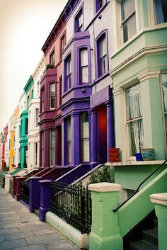 a row of multicolored houses on the street