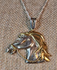 The delicate artistry of this lovely pendant necklace is a testament to the jeweler who created it, with fluid lines and equine design. Sterling horse head with gold plated mane and bridle rein, attached to a delicate sterling silver chain with lobster claw clasp, stamped Origenes OR Oridenes on the back with a MX for Mexico stamp, c1970s. Chain measures 14 inches long, pendant measures 1 x 1 ½ inches. Classic Horse Design Pendant Necklace, Formal Horse Design Pendant Jewelry, Elegant Formal Necklace With Horse Design, Mexico Stamp, Chunky Silver Jewellery, Vintage Pendant Necklace, Vintage Pendant, Long Pendant, Horse Head