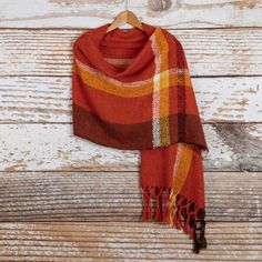 With the changing colors of the leaves in the fall in mind, the Ulloa family of artisans from Peru design this gorgeous shawl in flame, marigold, mahogany and wine. The shawl is hand-woven on artisanal looms with 100% alpaca and its shades are so full of life that will make any outfit stand out. Woven Shawls, Alpaca Shawl, Striped Shawl, Poncho Shawl, Loom Weaving, In The Fall, Shawls And Wraps, Winter Scarf, Plaid Scarf