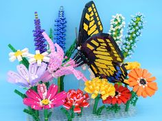 colorful plastic flowers and a butterfly on a blue background