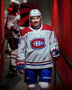 a hockey player is walking down the tunnel