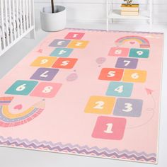 a child's play mat with numbers and shapes on it in a white room