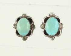 Vintage Sterling Turquoise Southwestern Earrings. These dainty hand made earrings each feature one oval turquoise cabochon in saw tooth bezel and framed with scrolls and balls. The dainty stud earrings measure 3/8" X 7/16" and are finished with posts and replacement butterfly backs. In very good vintage condition with lovely patina and no damage noted. ERA: Mid Century, 1970s METAL/MATERIALS:  925 Sterling Silver (tested) and Turquoise HALLMARKS/HISTORY: Earrings are unmarked and replacement bac Traditional Turquoise Sterling Silver Earrings, Vintage Turquoise And Sterling Large Oval Stud Earrings, Vintage Multi-stone Turquoise Jewelry, Turquoise Clip-on Round Earrings, Turquoise Southwestern Nickel-free Hoop Earrings, Dainty Studs, How To Make Earrings, Turquoise Sterling Silver, Earings Piercings