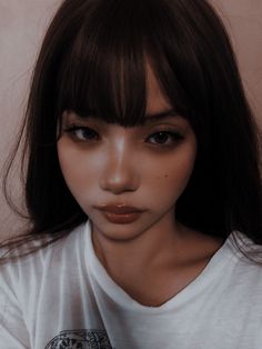 a close up of a person wearing a white t - shirt with dark hair and bangs