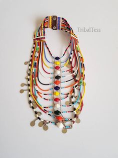 This necklace is 100% handcrafted using colorful fine beads. Perfect for weddings, traditional events, African themed events ect. The necklace has 13 strands all joined together. It has a leather closure with 2 buttons. Buy multiple items and pay shipping for ONE item only. **This necklace ships via DHL Express.(They take 3 to 5 days). More neckleces here; https://www.etsy.com/shop/TribalTess?ref=seller-platform-mcnav&section_id=21306083 Back to my shop; https://www.etsy.com/shop/TribalTess? Traditional Multicolor Beaded Bridal Necklace, Handmade Multicolor Bridal Necklace With Round Beads, Multicolor Polished Round Beads Bridal Necklace, Multicolor Bridal Necklace With Polished Round Beads, Multicolor Necklace For Traditional Festivals, Multicolor Necklaces For Traditional Ceremonies And Festivals, Multicolor Necklaces For Festivals And Traditional Ceremonies, White Beaded Choker For Festivals, Traditional Multicolor Beaded Necklaces For Ceremonies