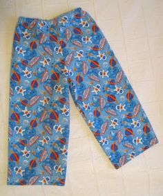 the pants are blue with red and orange designs on them, along with white sheets