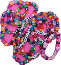 Fun Beaded Bracelets For Festival, Handmade Plastic Bracelets For Festival, Cute Pink Festival Friendship Bracelets, Cute Pink Friendship Bracelets For Festivals, Pink Rave Jewelry For Festival, Fun Pink Beaded Bracelets For Party, Playful Pink Beaded Bracelets For Festivals, Colorful Friendship Bracelets With Letter Beads For Festival, Colorful Letter Beads Friendship Bracelets For Festivals