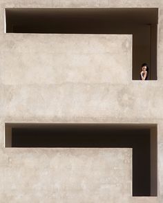 a person is taking a picture from the window of a building with two shelves on each side