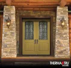 a yellow double door with two sidelights and brick pillars on the front of a house