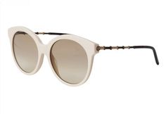 The glasses ship insured Priority Mail and may require a signature for delivery. These guaranteed authentic, NWT GUCCI Ivory Round Cat Eye Sunglasses, style #GG0653S, color code 004, have a 55mm lens width, 18mm bridge width, and a 145mm temple length. The sunglasses have an ivory round cat eye front frame with Dark Gold metal and tan bamboo arms accented with tortoise ear pieces. The lenses are light brown gradient, UV protection with a Category 1 Filter.   The sunglasses have the iconic interl Luxury Cream Sunglasses With Gradient Lenses, Gucci White Sunglasses With Uv Protection, Gucci Beige Tinted Sunglasses, Classic White Round Frame Sunglasses, White Cat Eye Sunglasses For Formal Occasions, Luxury White Gucci Sunglasses, Formal White Cat Eye Sunglasses, White Round Frame Sunglasses With Gradient Lenses, Elegant White Gucci Sunglasses