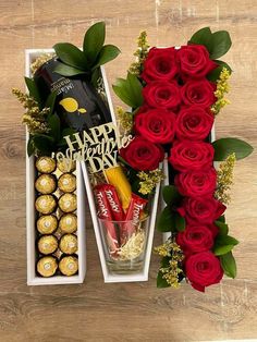 roses and chocolates are arranged in boxes on a table