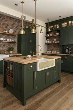 a large kitchen with green cabinets and gold accents on the counter tops, along with wooden flooring