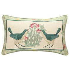 two birds sitting on top of a pillow with red flowers in the middle of it