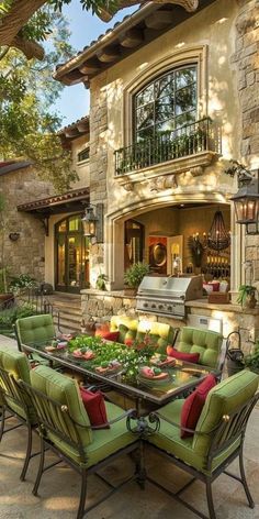 an outdoor dining area with green chairs and a grill