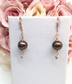 A Gorgeous, Semi-Round, Freshwater Chocolate Pearl with high luster and a thick nacre is featured. Size 10-11mm. Served up in 14k Rose Gold Filled, there is a scalloped flower cap on top of the pearl. Below the pearl dangles a 16k White Gold Plated bezeled CZ dot. I've made it so it swings when you move. The quality earring hook is 16k Rose Gold Plated, comfort curved, with beaded detail around the Pave set CZ's. This would make an excellent earring for your Bridesmaids as it is a very versatile Rose Gold Pearl Drop Jewelry For Party, Party Rose Gold Jewelry With Pearl Drop, Party Rose Gold Pearl Drop Jewelry, Rose Gold Dangle Pearl Earrings For Party, Rose Gold Dangle Pearl Party Earrings, Rose Gold Teardrop Pearl Earrings For Party, Bridesmaid Chocolate, Chocolate Pearls, Earring Dangle