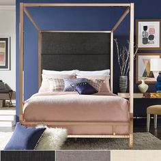 a bedroom with blue walls and furniture in the room, including a four poster bed