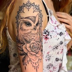 a woman with a tattoo on her arm has an owl and roses in the frame