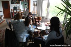 four women sitting at a table in a living room