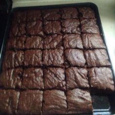 a pan filled with brownies sitting on top of a counter