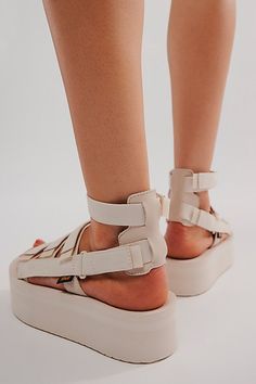 Reach new heights in these upgraded Teva gladiator-style sandals featuring an elevated flatform sole and organic cotton straps with multiple points of adjustability for your perfect fit. * Hook-and-loop closures for adjustable fit * Rubber sawtooth outsole * Molded EVA midsole * Removable ankle strap | Teva Flatform Mevia Sandals at Free People in White, Size: US 10 Spring Ankle Wrap Sandals With Strap, Summer Adjustable Platform Footbed Sandals, Spring Beach Footbed Sandals With Chunky Platform, Beige Ankle Strap Footbed Sandals For Summer, Beige Platform Footbed Sandals For Summer, Summer Platform Footbed Sandals With Ankle Strap, Beige Sport Sandals With Cushioned Footbed For Summer, Summer Beige Platform Footbed Sandals, Spring Flat Sport Sandals With Adjustable Strap