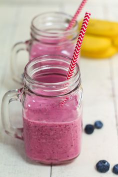 a pink smoothie in a mason jar with a straw