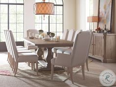 a dining room table with chairs and a chandelier