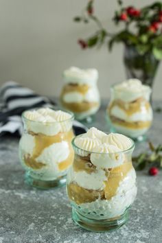 four desserts in small glass dishes on a table