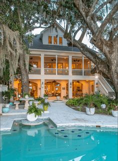 a large white house sitting next to a swimming pool