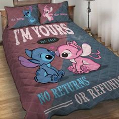 the bed is made with pink and blue comforters, which have cartoon characters on them