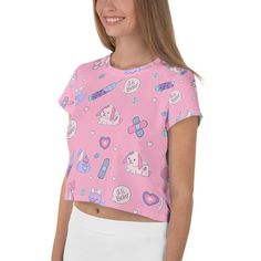 "A kawaii pink and purple menhera shirt featuring Nurse Ducky making it all better for her sickly cute bunny and teddy bear, and duck patients. This boxy cropped t-shirt, which has a slightly silky, knit feel, also has contrasting bandages, pills, and syringes. It's unisex and would be a comfy casual addition to your menhera wardrobe without being aggressive. Double check sizing before ordering. Would be a great present for those in the medical field. Apparel and bedding ship separate from handm Fitted Pink Harajuku Style Tops, Pink Crew Neck T-shirt With Cute Design, Fitted Pink Tops With Cartoon Print, Kawaii Cute Crew Neck Tops, Kawaii Crew Neck Top With Cute Design, Cute Kawaii Crew Neck Top, Pink Cotton Anime Print Tops, Pink Anime Print Cotton Top, Pink Short Sleeve Top With Hello Kitty Print