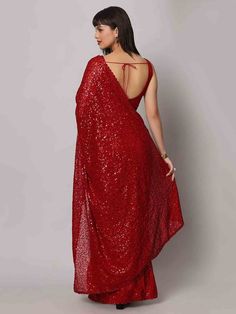 Wear this stunning red sequins georgette cocktail party wear a saree with a blouse and make heads turn at any event. Designed with intricate sequin work and a beautiful sequin floral border, this saree is made from high-quality georgette material that ensures comfort and elegance. The heavy sequin work on both the saree and blouse adds a touch of glamour to your outfit, making it perfect for parties and receptions.
This designer saree comes in a vibrant red color that exudes grace and sophistica Festive Pre-draped Saree With Zari Work For Party, Glamorous Festive Pre-draped Saree For Celebration, Bollywood Style Festive Pre-draped Saree With Sequins, Sequin Pre-draped Chinon Saree, Pre-draped Saree With Dupatta For Navratri Party, Bollywood Style Pre-draped Saree With Sequins, Glamorous Sequined Pre-draped Saree For Festivals, Bollywood Style Floor-length Pre-draped Saree For Parties, Party Wear Pre-draped Sequined Saree For Festivals