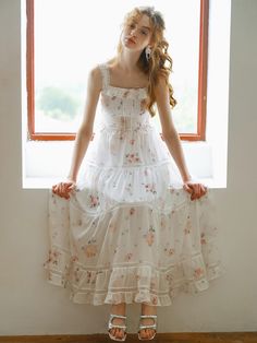 This product, the Cest Sweet Floral Slimming Dress, beautifully combines romantic floral patterns with a flattering silhouette. The dress features a fitted bodice with delicate straps and a flowing tiered skirt, creating an ethereal and feminine look. The intricate lace detailing adds a touch of elegance, making it perfect for both casual outings and special occasions. - This dress showcases a fitted bodice with delicate straps, enhancing its romantic appeal.- The tiered skirt flows gracefully, providing a flattering and slimming silhouette.- Intricate lace detailing adds sophistication and elegance to the overall design.- The floral pattern is charming and timeless, suitable for various events.- A handmade Cali medal decoration has been attached to the lower right side of the front p Delicate Summer Dress With Fitted Bodice, Tiered Dress With Adjustable Straps For Garden Party, Delicate Sleeveless Dress With Fitted Bodice, Tiered Garden Party Dress With Adjustable Straps, Delicate Fitted Bodice Sleeveless Dresses, Feminine Floral Dress With Ruffled Straps For Garden Party, Cottagecore Tiered Skirt Dress For Garden Party, Tiered Floral Dress With Smocked Bodice For Garden Party, Cottagecore Tiered Dress For Garden Party