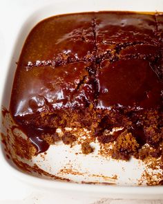 a close up of a cake in a pan with frosting and chocolate on top