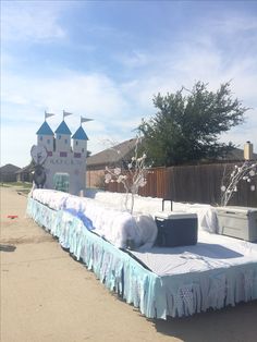 there is a bed made out of mattresses on the ground in front of a building