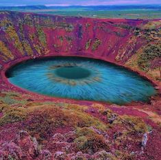 a large blue hole in the middle of a mountain