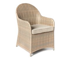 a wicker chair with a cushion on the back and arm rests against a white background