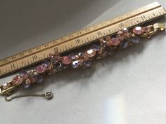 "Delizza and Elster, Juliana design with pink rhinestones and givre lavender satin glass teardrop accents. Beautiful, sparkling diamond like gems on this lovely link bracelet with a gold finish. A larger pink chaton is on a link that links two other ornate gem clusters. A total of five clusters and six large gem connectors. There is a chain guard as well as the very secure clasp. Wear this lovely bracelet on your fanciest outing. Quite a stunning and rare Juliana by Deliza and Elster from their Pink Crystal Bracelet With Rhinestones, Pink Crystal Bracelet With Sparkling Stones For Party, Pink Crystal Bracelet For Formal Occasions, Pink Crystal Bracelets For Formal Occasions, Formal Pink Crystal Bracelet, Elegant Pink Bling Bracelets, Elegant Pink Jeweled Bracelets, Pink Evening Jewelry With Bling, Pink Bling Jewelry For Evening