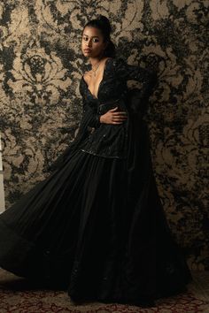 This black Kurta Set epitomizes graceful elegance with its exquisite design and attention to detail. The kurta, crafted in classic black, is adorned with intricate thread and cutdana tonal embroidery, adding a touch of sophistication and charm. Paired with a flowing organza skirt, the ensemble exudes ethereal beauty, while the organza peplum adds a modern twist with its delicate draping and embroidery. Together, these elements create a harmonious ensemble that seamlessly blends tradition with co Kurta And Lehenga, Lehenga Black, Black Kurta Set, Black Kurta, Tonal Embroidery, Organza Skirt, Summer Romance, Black Tie Event, Ethereal Beauty