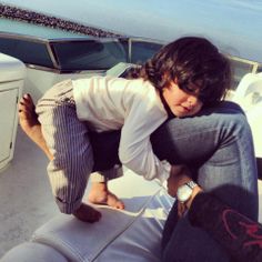 a young child is sitting on the back of a boat