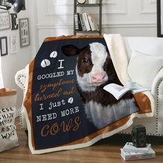 a brown and white cow sitting on top of a couch