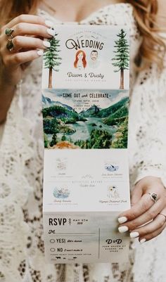 a woman holding up a wedding program in front of her face with trees on it